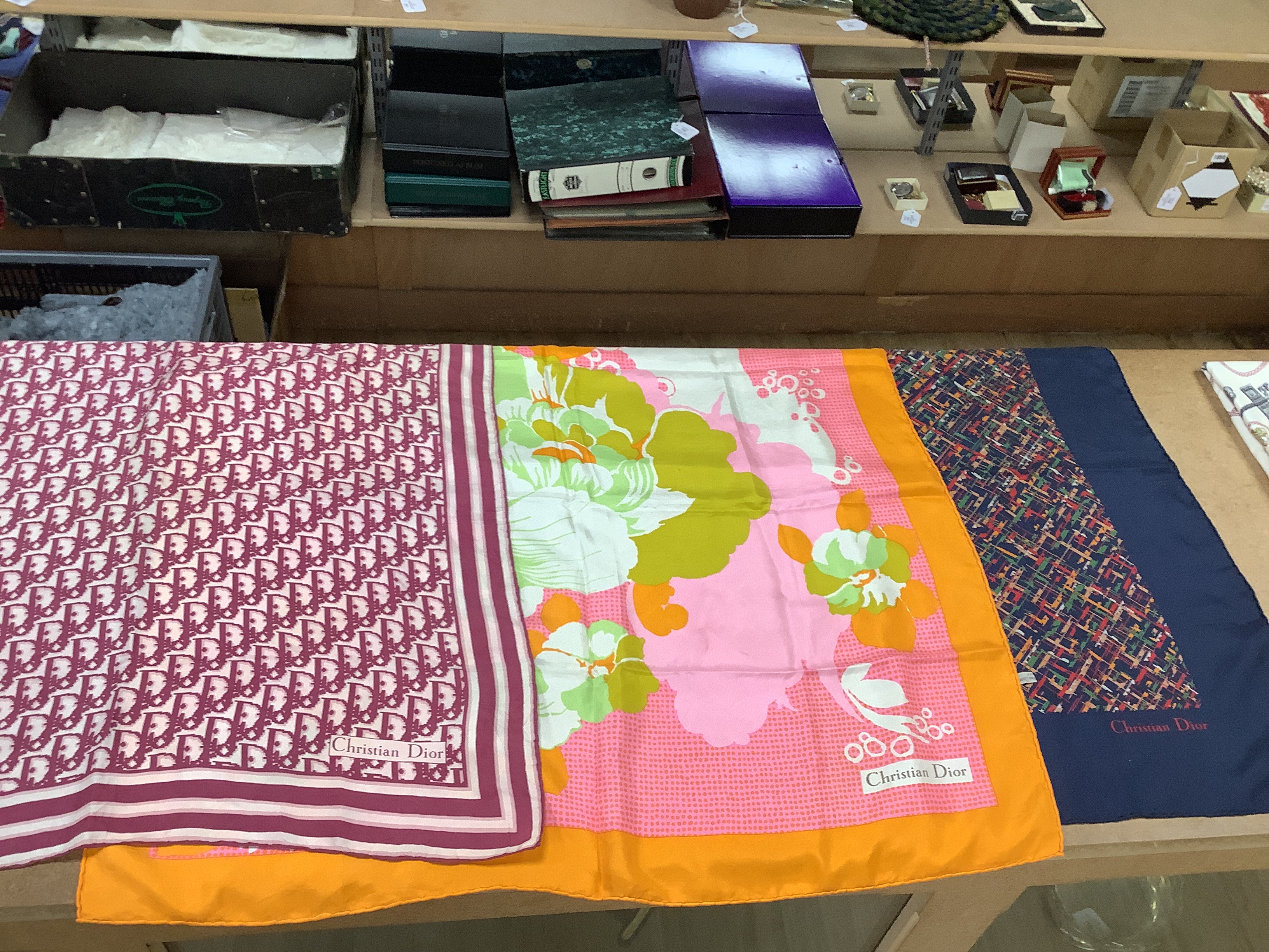 A Hermes, Paris silk scarf “Les Cles Bordeaux” with pink border and three Christian Dior silk scarves